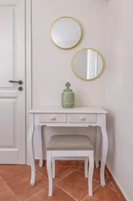 a white dressing table with a mirror and a stool at Nikolas Old Town in Rhodes Town
