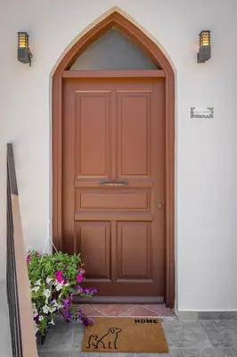 a wooden door with an arch above it at Nikolas Old Town in Rhodes Town