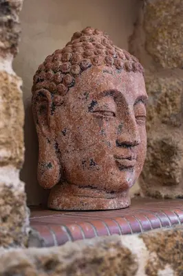 a statue of a head is sitting on a table at Nikolas Old Town in Rhodes Town