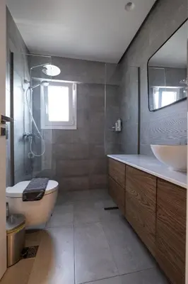 a bathroom with a tub and a sink and a toilet at Savvina's residence in Rhodes Town