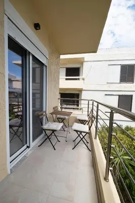 a balcony with chairs and a table on it at Savvina's residence in Rhodes Town