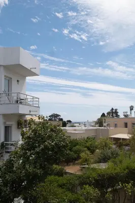 a view of a building with trees and buildings at Savvina's residence in Rhodes Town