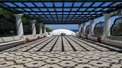 a walkway with a large building in the background at Agapi's Seaside Place in Faliraki