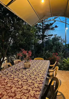 a table with a vase of flowers on top of it at Agapi's Seaside Place in Faliraki