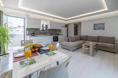 a kitchen and living room with a table with fruit on it at Demiani House in Lardos