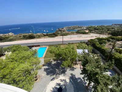 an overhead view of a swimming pool and the ocean at Kallithea Residence in Koskinou