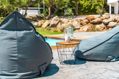 a tent and a table next to a swimming pool at Kallithea Residence in Koskinou