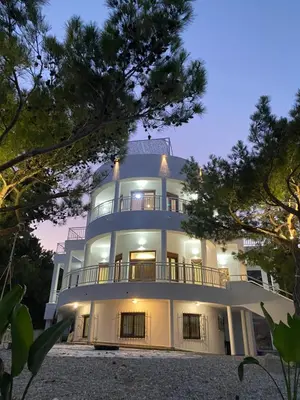 a large white building with a balcony at Kallithea Residence in Koskinou