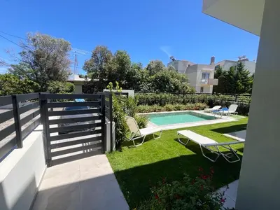 a backyard with a swimming pool and a fence at Green Villa in Ialyssos