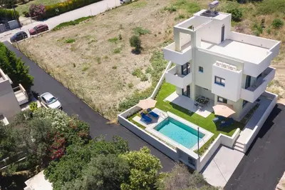 an aerial view of a white house with a swimming pool at Green Villa in Ialyssos