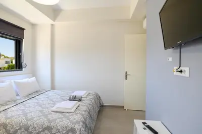 a bedroom with a bed with towels on it at Green Villa in Ialyssos