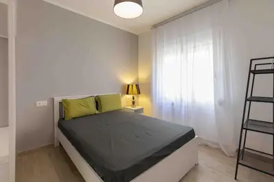 a bedroom with a bed and a window at Luxury cozy appartment in the city center in Rhodes Town