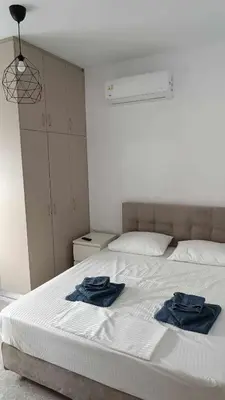 two towels on a bed in a room at Restaurant Maria Suites SunSet in Faliraki