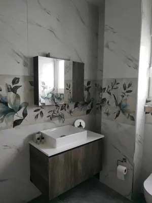 a bathroom with a sink and a mirror at Restaurant Maria Suites SunSet in Faliraki