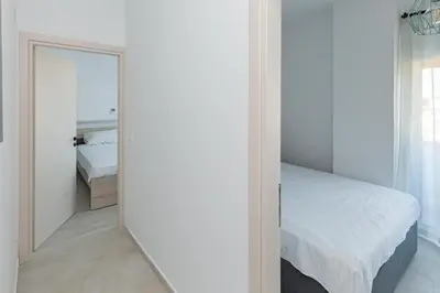 a bedroom with a mirror next to a bed at Rhodes City Center Apartments in Rhodes Town