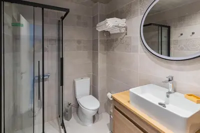 a bathroom with a shower and a toilet and a sink at Rhodes City Center Apartments in Rhodes Town