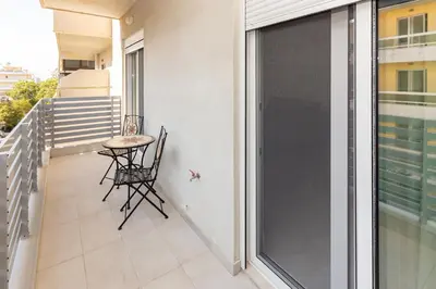 a balcony with a table and chairs on it at Rhodes City Center Apartments in Rhodes Town