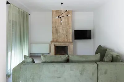 a living room with a couch and a fireplace at Rhodes City Center Apartments in Rhodes Town