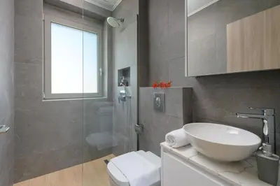 a bathroom with a toilet and a sink and a shower at Panaxia Villas in Theologos