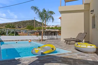 a swimming pool with two inflatable boats in a house at Alonia Traditional House in Malona in Malona Village