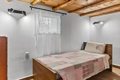 a bedroom with a bed and a window at Alonia Traditional House in Malona in Malona Village