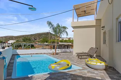 a house with a swimming pool and two inflatable boats at Alonia Traditional House in Malona in Malona Village