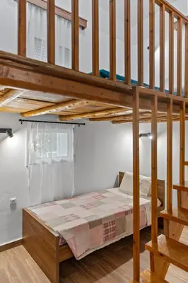 a bedroom with a bunk bed and a staircase at Alonia Traditional House in Malona in Malona Village