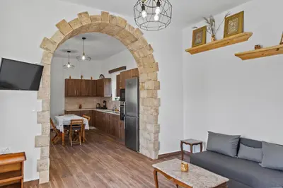 a living room with a couch and a kitchen at Alonia Traditional House in Malona in Malona Village