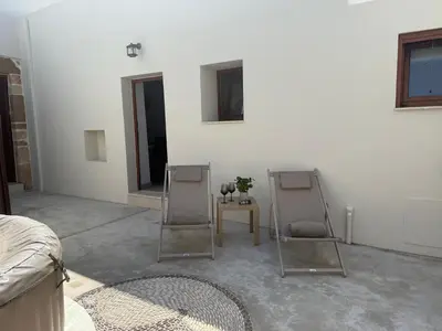 a living room with two mirrors and a table at Antica Casa Dei Nonni in Archangelos