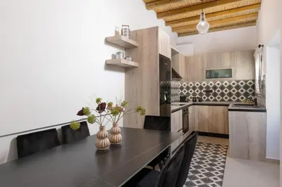 a kitchen with a black counter top in a room at Antica Casa Dei Nonni in Archangelos