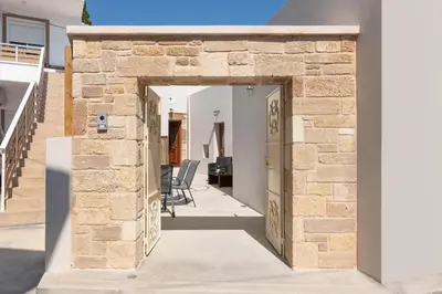 an entrance to a house with a stone wall at Antica Casa Dei Nonni in Archangelos