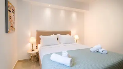 a bedroom with a bed with towels on it at Grace Luxury Apartment next to Old Town in Rhodes Town