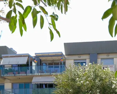 a building with a balcony in front of it at Grace Luxury Apartment next to Old Town in Rhodes Town