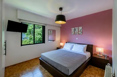 a bedroom with a large bed and a window at flower veranda 1st floor app in Rhodes Town