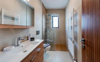 a bathroom with a white sink and a toilet at flower veranda 1st floor app in Rhodes Town