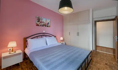 a bedroom with a bed with a blue comforter at flower veranda 1st floor app in Rhodes Town