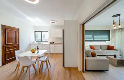 a kitchen and living room with a table and chairs at flower veranda 1st floor app in Rhodes Town