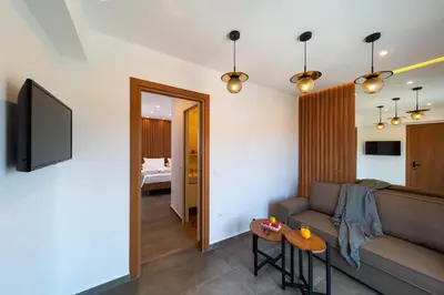 a living room with a couch and a table at Ventus Villas in Koskinou