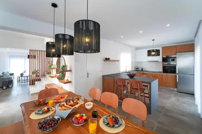 a kitchen and living room with a table with food on it at Ventus Villas in Koskinou