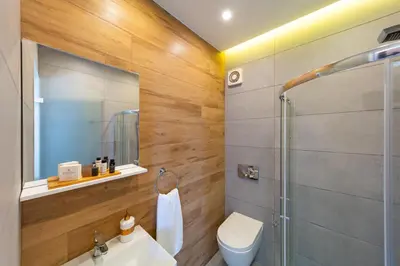 a bathroom with a shower and a toilet and a sink at Ventus Villas in Koskinou