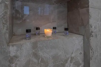 a candle sitting on a shelf in a bathroom at Diorisa House in Lardos