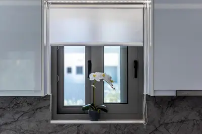 a window with a vase with a flower in it at Diorisa House in Lardos