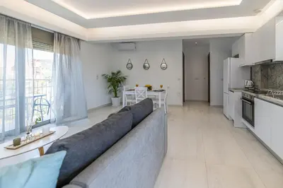 a living room with a couch and a kitchen at Diorisa House in Lardos