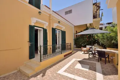 a patio with a table and an umbrella on a building at Casa Di Rodi in Rhodes Town