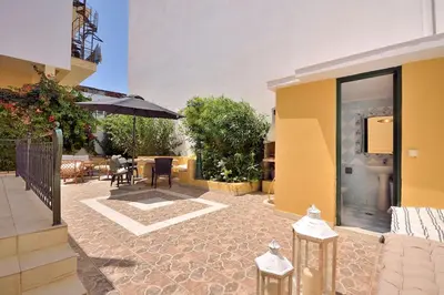 a patio with a table and an umbrella at Casa Di Rodi in Rhodes Town