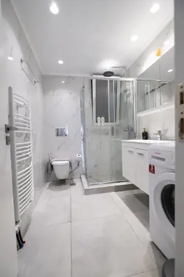 a white bathroom with a shower and a toilet at Verde Casa luxury apartment close to old town in Rhodes Town