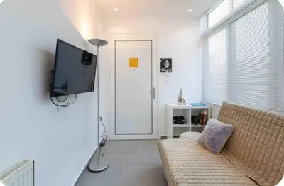 a living room with a couch and a flat screen tv at Verde Casa luxury apartment close to old town in Rhodes Town