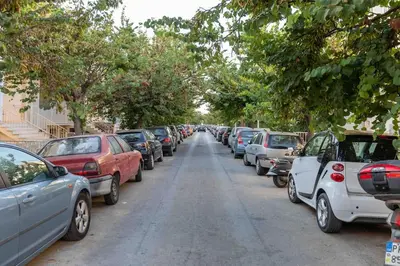 a row of cars parked on the side of a street at Verde Casa luxury apartment close to old town in Rhodes Town