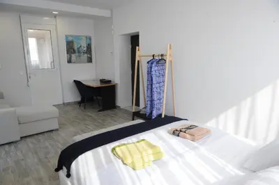 a bedroom with a bed and a desk and a chair at El Angel by Ntinos in Kremasti