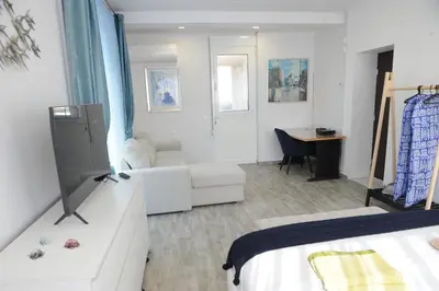 a bedroom with a bed and a living room at El Angel by Ntinos in Kremasti